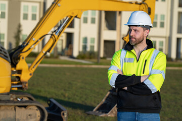 Worker with bulldozer on site construction. Man excavator worker. Construction driver worker with excavator on the background. Construction worker with tractor or construction vehicle at building.
