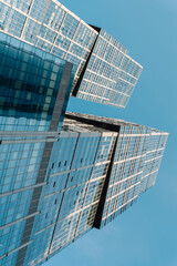bottom view of the tall skyscrapers of the business district of a modern city