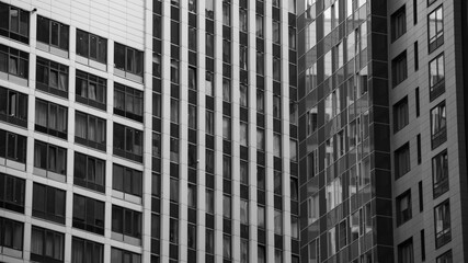 Fototapeta premium empty glass windows of a modern building with a reflection of the sky in the glass