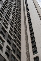 empty glass windows of a modern building with a reflection of the sky in the glass