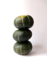 Fresh pumpkins on a white background. Pumpkins stacked on top.
