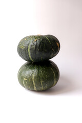 Fresh pumpkins on a white background. Pumpkins stacked on top.