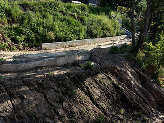 Building a new road on a hill. Erosion landscape restoration concept. Handheld mobile photo,...