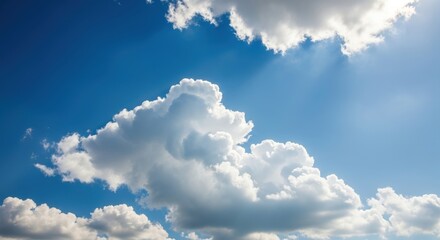 fluffy white clouds in a bright blue sky with sun rays