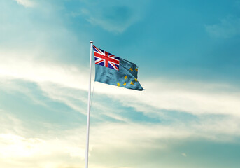 Tuvalu flag is waving on a tall flagpole among the clouds. Tuvalu national flag for independence...