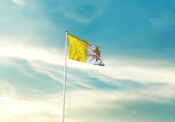 Vatican City flag is waving on a tall flagpole among the clouds. Vatican City national flag for independence day.