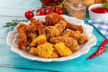 Golden crispy fried chicken mix - wings, drumsticks, nuggets and strips