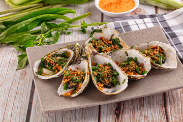 Gournet grilled oysters with onion and peanut