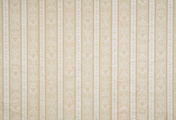 Old wallpaper on the wall. Old wallpaper for texture or background.