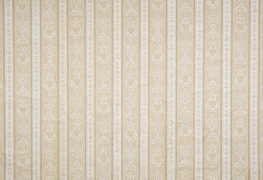 Old wallpaper on the wall. Old wallpaper for texture or background.