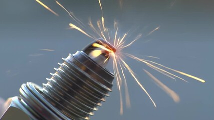 Silver spark plug emits golden sparks against a soft gray backdrop, close up view