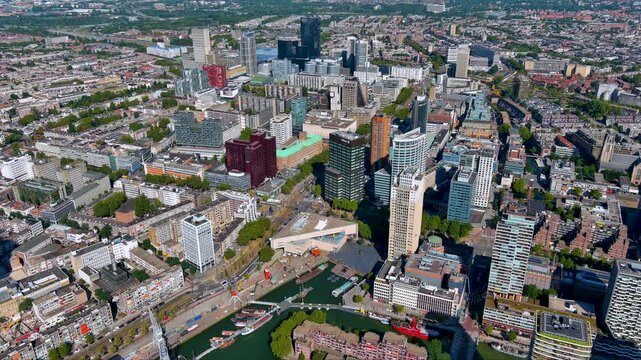4K aerial drone panorama of Rotterdam city center with modern high-rises, the Maritime Museum harbor and historic ships in Leuvehaven showcasing the energy of the Netherlands&rsquo; leading port city.