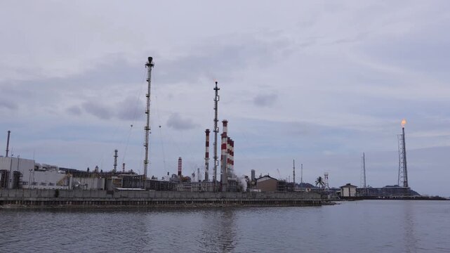 Pertamina Oil and gas refinery industry, equipment details Steel oil pipelines with valves from large oil storage tanks.