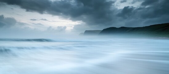 Fototapeta premium Dramatic Seascape with Misty Cliffs and Long Exposure Waves