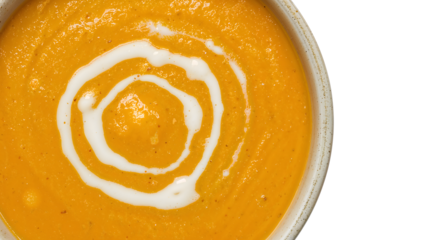 Closeup of creamy pumpkin soup with coconut milk swirl in rustic bowl on the transparent background