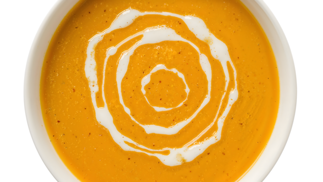 Creamy pumpkin soup with swirl of cream in white bowl on the transparent background  healthy autumn comfort food trend