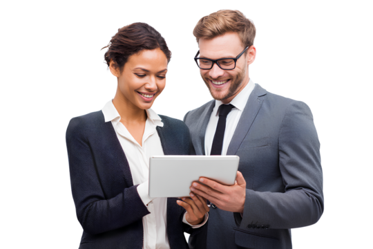 A man and woman in business attire standing together, smiling while looking at an iPad screen, isolated on a transparent background