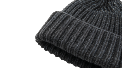 Closeup detail of black knitted wool beanie hat on the transparent background showcasing cozy winter fashion accessory texture