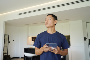 Worker with tablet computer checking alarm system