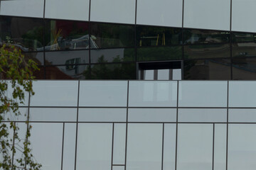 There is a strikingly designed building that features numerous large windows and has a beautiful...