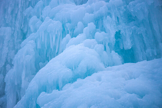 Winter ice climbing crag in the Alps. Imst Pitztal area famous for its frozen waterfalls in winter. Huge ice stalactites hanging on the wall of a canyon in the Alps. Winter ice climbing extreme sports