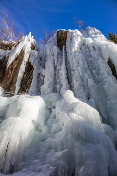Winter ice climbing crag in the Alps. Imst Pitztal area famous for its frozen waterfalls in winter. Huge ice stalactites hanging on the wall of a canyon in the Alps. Winter ice climbing extreme sports