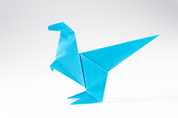 Paper dinosaur on white background. Origami animals. Paper crafts.