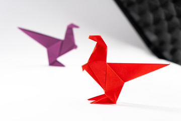 Paper dinosaur on white background. Origami animals. Paper crafts.