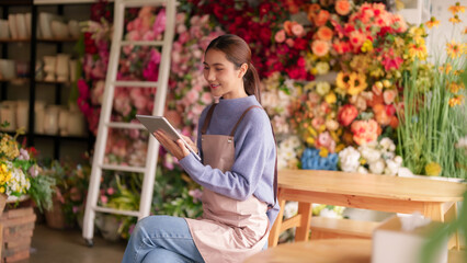 Asian Adult Florist Manages Flower Shop Business Digital Sales Operations Using Tablet Technology Modern Retail © snowing12