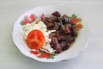 Traditional Indonesian Lamb Satay with Cabbage and Tomato Slices