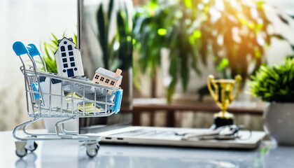 Property investment concept with miniature houses in cart