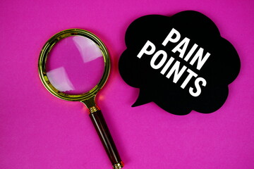 Pain Points text with speech bubble and magnifying glass on pink background