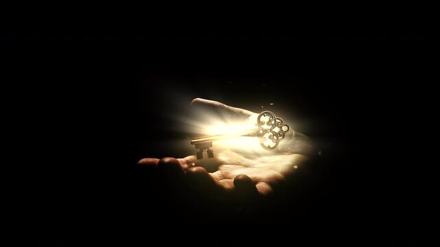 Magic ancient golden key with bright glow from light rays in magic flying dust slowly hovers over human palm isolated on black. Idea of awareness, open mind, awakening. Conceptual 4k slow motion video