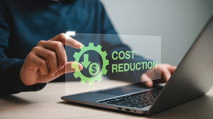 Businessman using laptop with cost reduction concept, financial savings visualized
