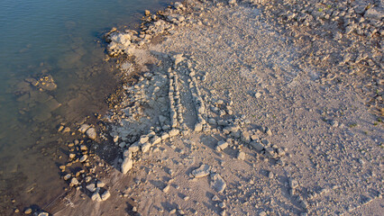 Ancient nuraghe and giants' tomb submerged by Monte Prano lake in Tratalias Sardinia