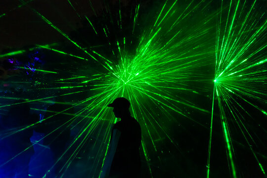 Silhouette of a person in front of green laser burst, Kings Park, Perth, Australia