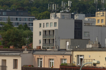 Fototapeta premium A row of tall buildings featuring antennas installed on the rooftops, showcasing modern urban architecture and design elements