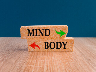 Concept words mind OR body on brick blocks with two arrows. Mental health over physical health...