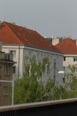A long row of picturesque buildings topped with charming red tile roofs stretches out along the street, creating a stunning urban landscape