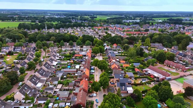 Beautiful residential area with lovely houses and lots of greenery. Footage over the town in the Netherlands.