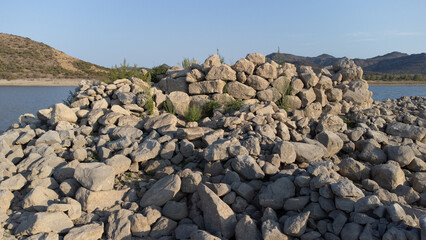 Ancient nuraghe and giants' tomb submerged by Monte Prano lake in Tratalias Sardinia