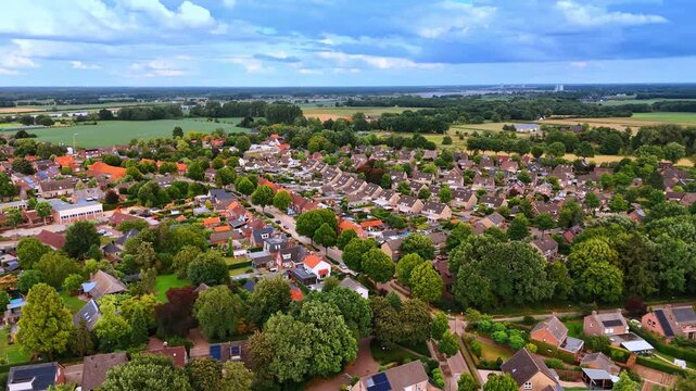 Numerous similar houses in the panorama of lovely town. Drone footage over the scenery of the Netherlands on cloudy day.