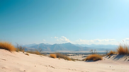 A serene desert landscape with sand dunes and a distant mountain range under a clear blue sky.