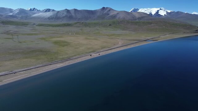 Aerial drone view of Pumo Yumco Lake with majestic Kula Kangri peaks in the Himalayas, at 5300m altitude, in Lhoka, Tibet.