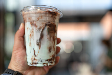 A glass of iced choc mint. A beverage best served chilled, as an chocolate-mint iced concoction takes the limelight