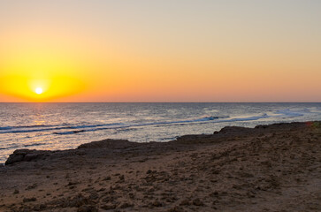 Golden sunset with calm waves and sandy coastline in Egypt 2 March 2025