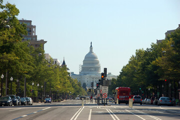 View down Pennsylvania Avenue in Washington, D.C., with the U.S. Capitol building framed by trees...