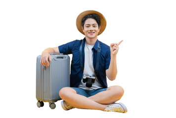 A young man ready for his next travel adventure, sitting next to his luggage. He points to the...
