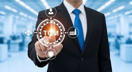 Professional businessman points to TQM concept with icons for quality, people, and industry in modern office environment