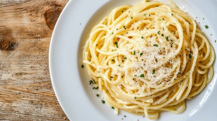 A plate of spaghetti topped with grated cheese and herbs, served on a wooden table, showcasing a delicious Italian dish.